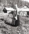 In this circa 1905 photo, Martha Knudsen, wife of Osmund, feeds chickens at the Knudsen homestead located in the hills east of modern-day Liberty Lake County Park.